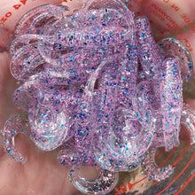 Load image into Gallery viewer, Color Code 0017: Clear Plastic with Pink Glitter, Silver Glitter, and Blue Glitter with UV (2 Inch Grub) in the Sunlight
