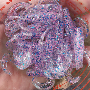 Color Code 0017: Clear Plastic with Pink Glitter, Silver Glitter, and Blue Glitter with UV (2 Inch Grub) in the Sunlight