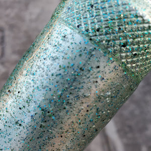 Color Code 0031 Clear Plastic with Fine Emerald Glitter, Fine Green Glitter, Black Glitter, and Gold Glitter (Subdued Sunlight)