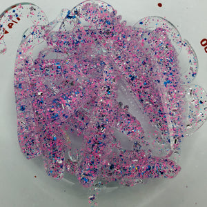 Color Code 0038:  Clear Plastic with pink glitter, blue glitter, silver glitter (Jumping Jack)
