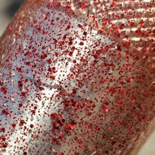 Load image into Gallery viewer, Color Code 0040:  Clear Plastic with small and fine red glitter in full sunlight
